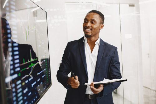 african-man-black-suit-big-tv-screen-guy-shows-presentation